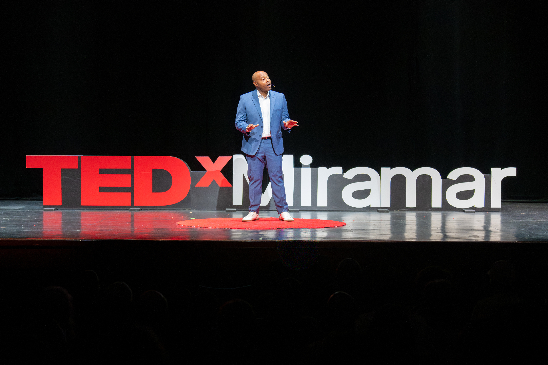 Anthony speaking on stage